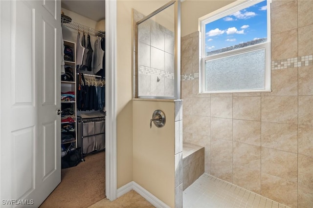 full bathroom with a walk in shower and a walk in closet