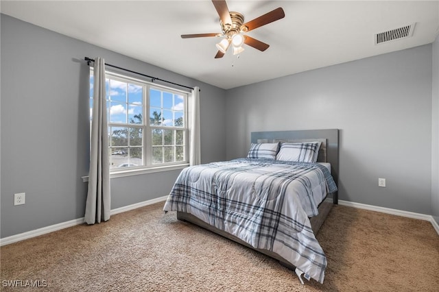 carpeted bedroom with baseboards, visible vents, and a ceiling fan