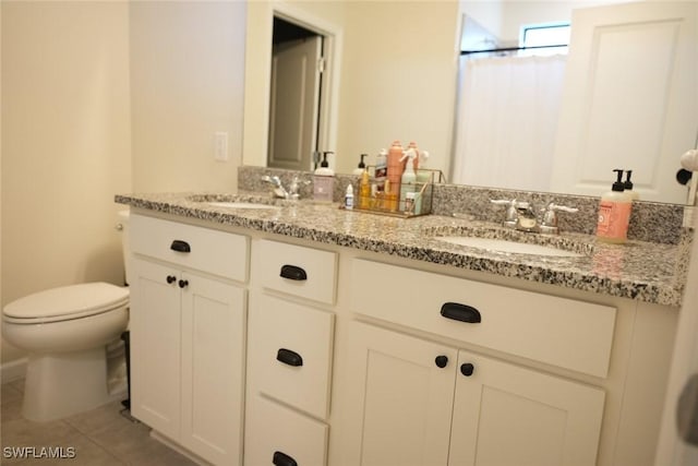 bathroom featuring vanity, tile patterned floors, and toilet