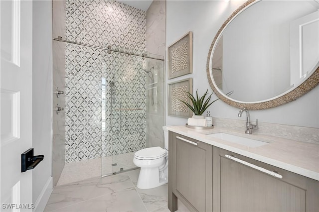 bathroom featuring tiled shower, vanity, and toilet