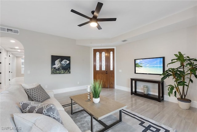 living room with ceiling fan and light hardwood / wood-style flooring