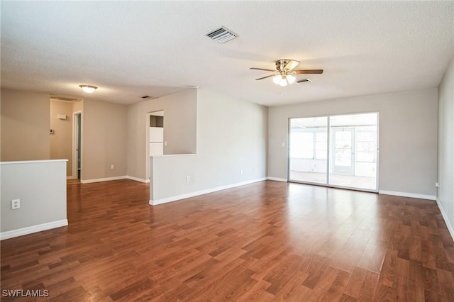 unfurnished room with ceiling fan, dark hardwood / wood-style floors, and a textured ceiling