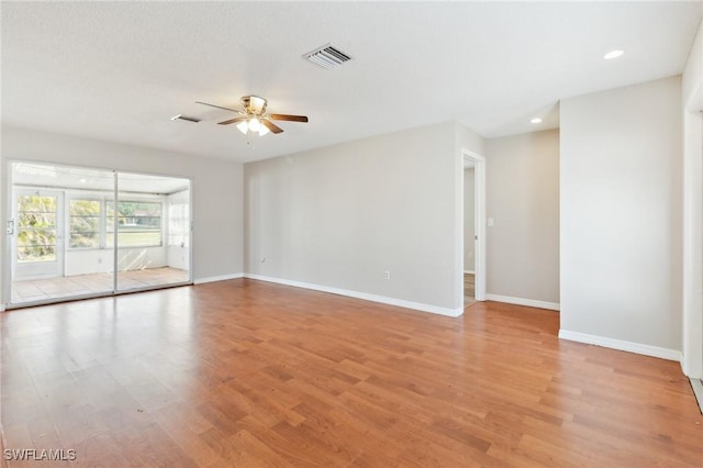 empty room with ceiling fan and light wood-type flooring