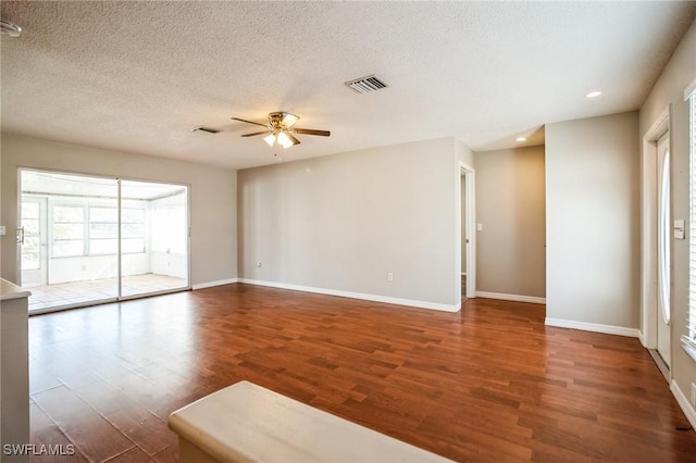 spare room with ceiling fan, dark hardwood / wood-style floors, and a textured ceiling