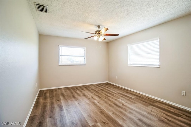 unfurnished room with hardwood / wood-style floors, a textured ceiling, and ceiling fan