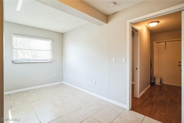 unfurnished room featuring a textured ceiling