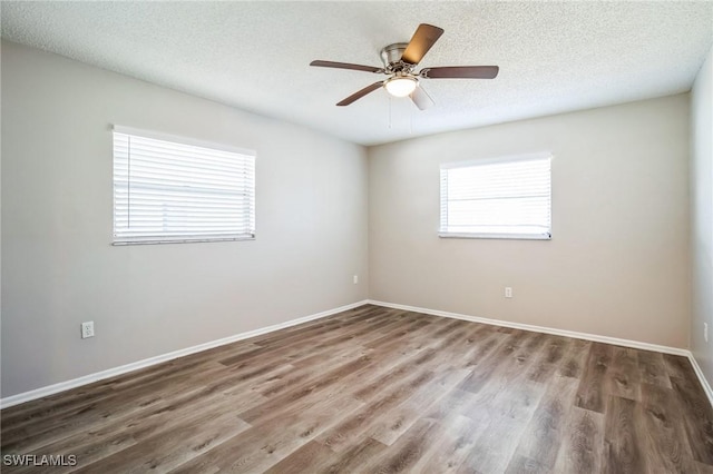 unfurnished room featuring ceiling fan, hardwood / wood-style flooring, and a textured ceiling