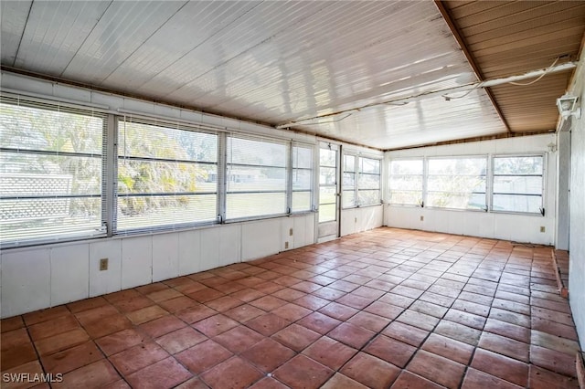 unfurnished sunroom featuring vaulted ceiling