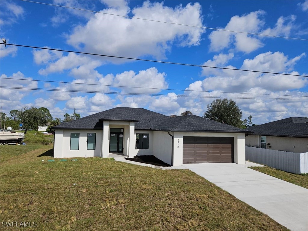 view of front of property featuring a garage and a front lawn