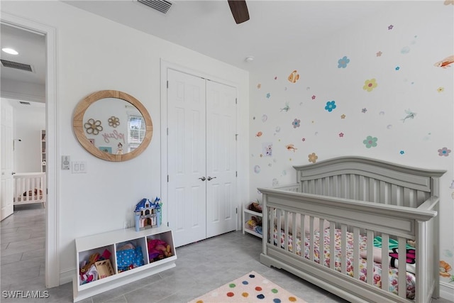 bedroom featuring ceiling fan, a closet, and a nursery area