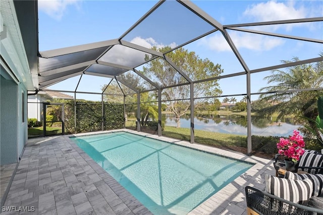 view of swimming pool featuring a lanai, a water view, and a patio area