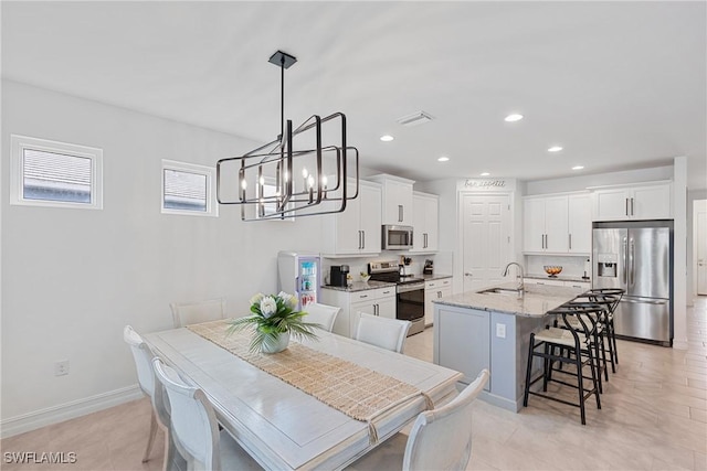 dining room featuring sink and an inviting chandelier