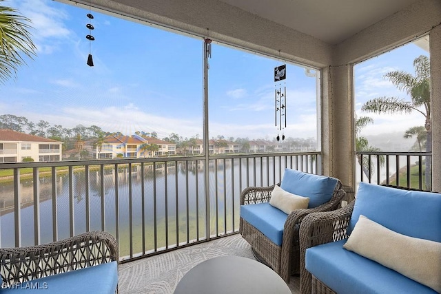 sunroom / solarium with a water view