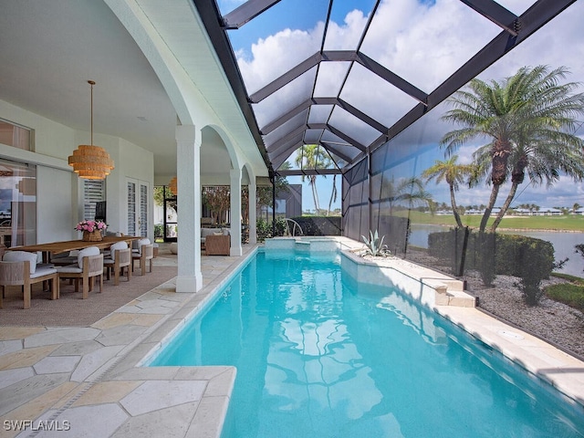 view of pool with a water view, a lanai, and a patio area