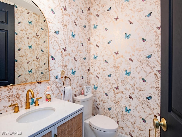 bathroom with toilet and vanity