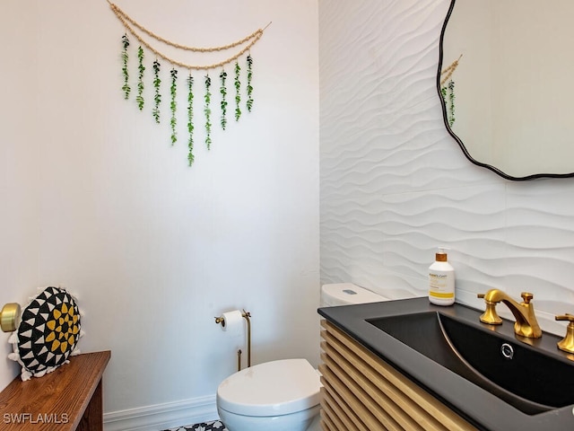 bathroom featuring toilet and vanity