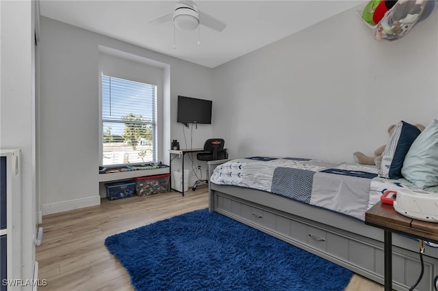 bedroom featuring hardwood / wood-style floors and ceiling fan