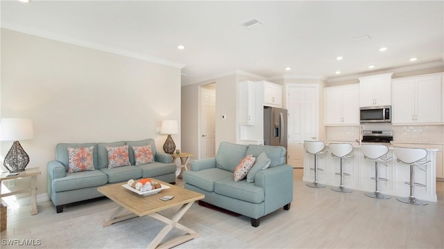 living room featuring light wood-style floors, recessed lighting, visible vents, and crown molding