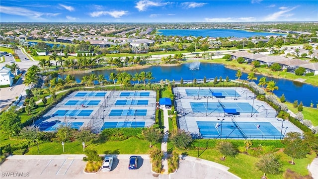 drone / aerial view featuring a water view and a residential view