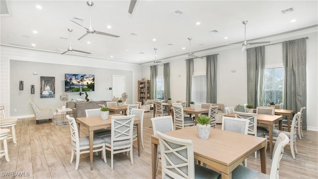 dining space featuring light wood-type flooring, visible vents, and ceiling fan