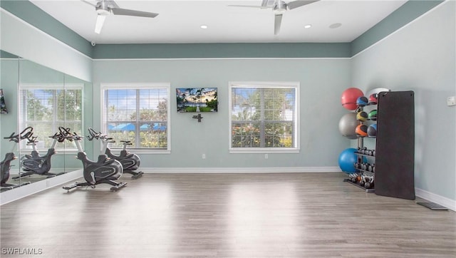 workout room featuring recessed lighting, wood finished floors, a ceiling fan, and baseboards