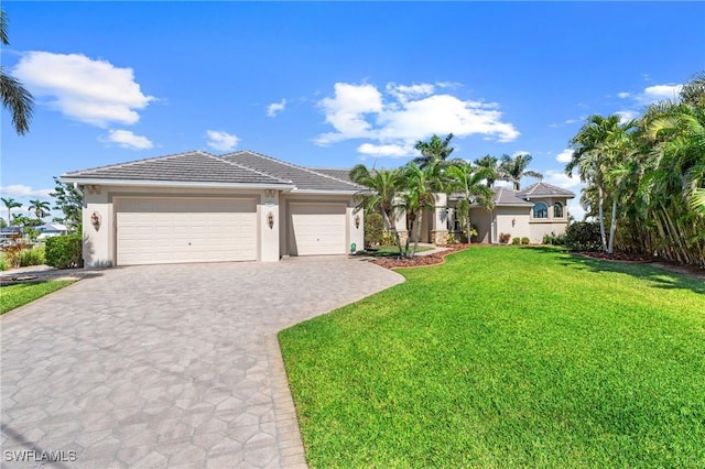 view of front of house with a garage and a front lawn