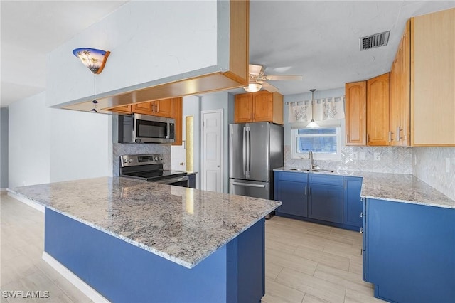 kitchen with sink, decorative backsplash, ceiling fan, light stone counters, and stainless steel appliances