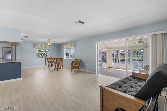 living room featuring ceiling fan and light hardwood / wood-style flooring