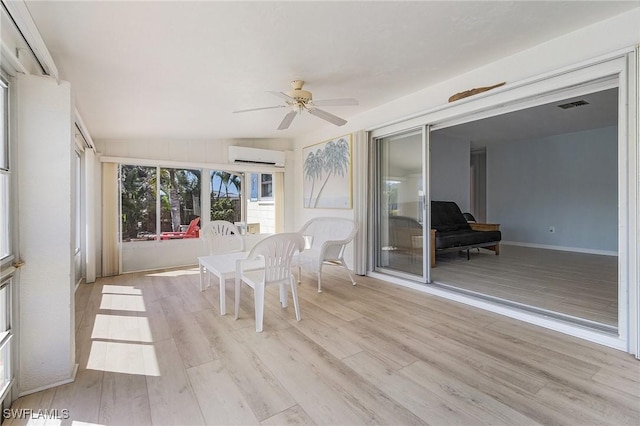 unfurnished sunroom featuring lofted ceiling, an AC wall unit, and ceiling fan