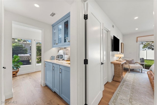 hall with light hardwood / wood-style flooring