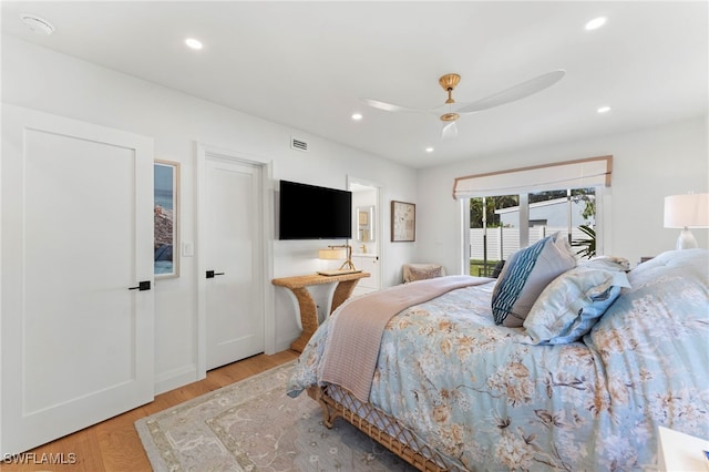 bedroom featuring hardwood / wood-style flooring, access to outside, and ceiling fan