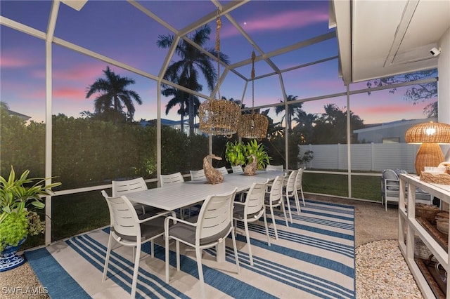 patio terrace at dusk featuring a lanai