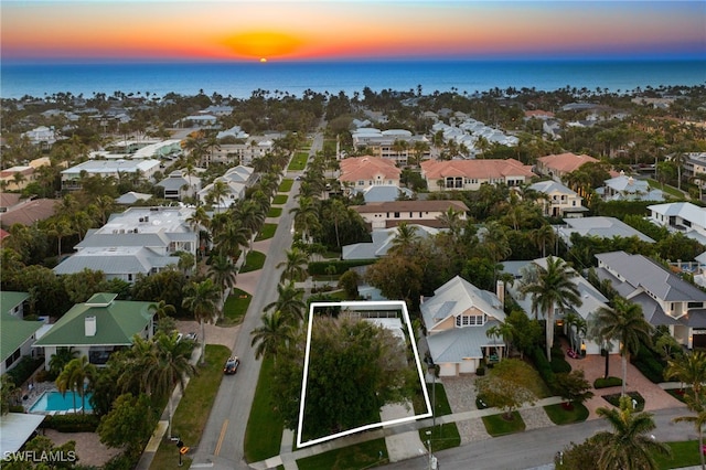 aerial view at dusk with a water view