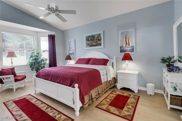 bedroom featuring ceiling fan, wood-type flooring, and vaulted ceiling