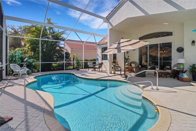 view of pool with a lanai and a patio area