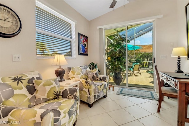 sitting room with vaulted ceiling, ceiling fan, and light tile patterned flooring