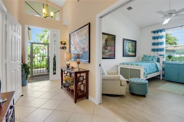 bedroom featuring access to exterior, a chandelier, vaulted ceiling, and light tile patterned floors