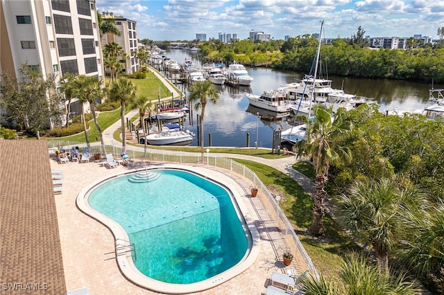 pool with a water view and a patio