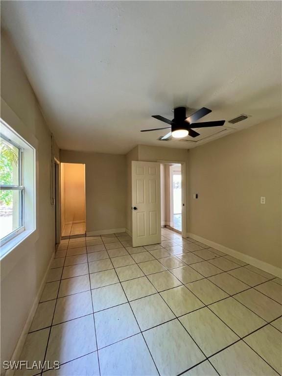 tiled empty room with ceiling fan