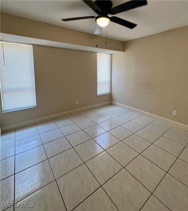 spare room featuring light tile patterned floors and ceiling fan