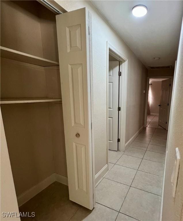 corridor with light tile patterned flooring