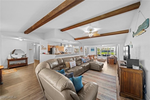 living room featuring ceiling fan, vaulted ceiling with beams, and light wood-type flooring