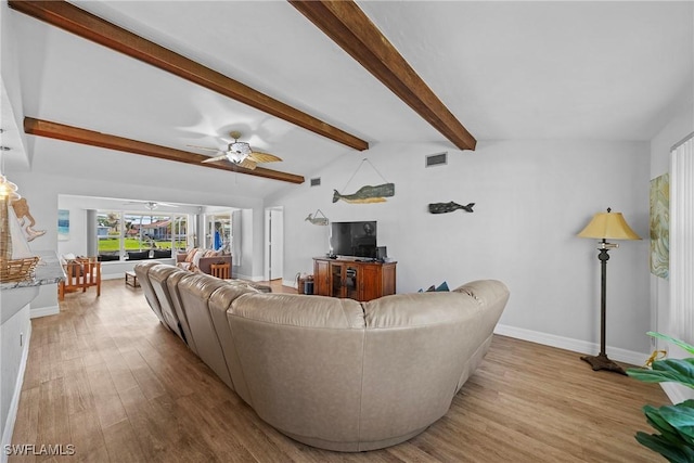 living room featuring ceiling fan, light hardwood / wood-style flooring, and vaulted ceiling with beams