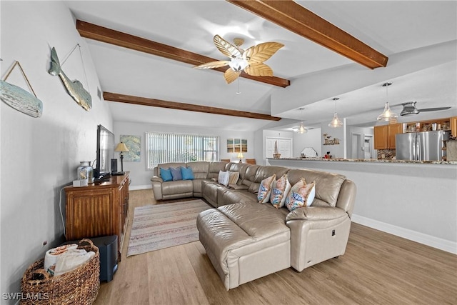 living room with vaulted ceiling with beams, ceiling fan, and light hardwood / wood-style flooring