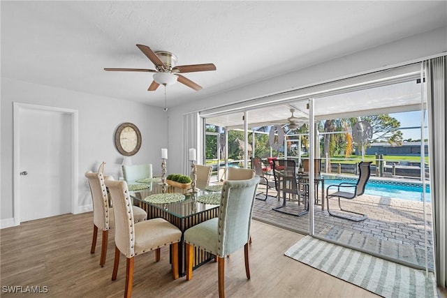 dining area with ceiling fan and light hardwood / wood-style floors