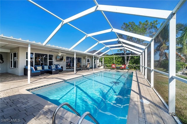 view of swimming pool with outdoor lounge area, ceiling fan, a lanai, and a patio