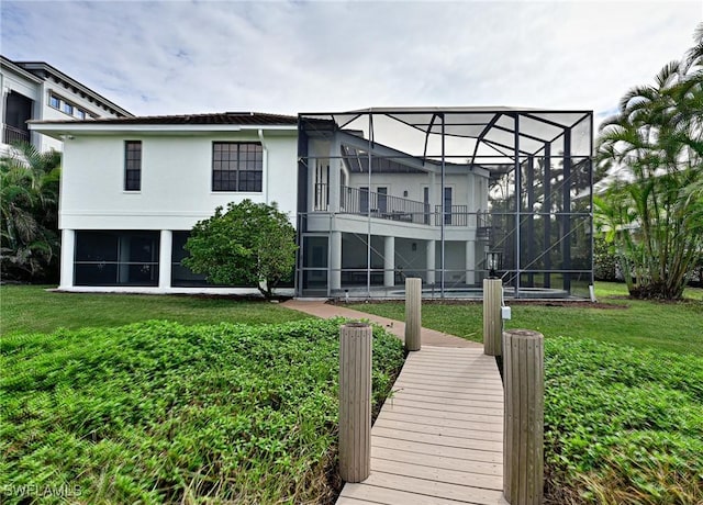 rear view of property featuring a lawn