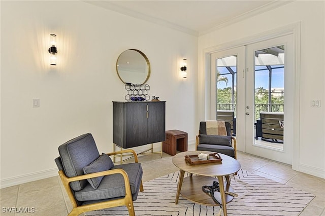 sitting room with french doors, crown molding, and light tile patterned floors