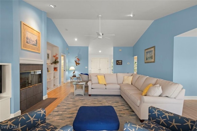 living area with lofted ceiling, a fireplace, dark wood finished floors, and baseboards