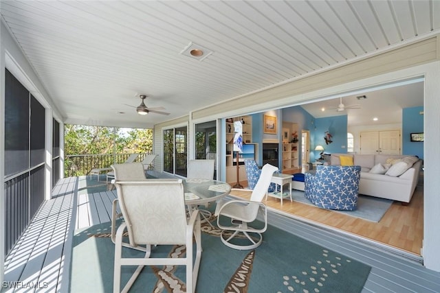 deck with a ceiling fan, outdoor dining space, and outdoor lounge area